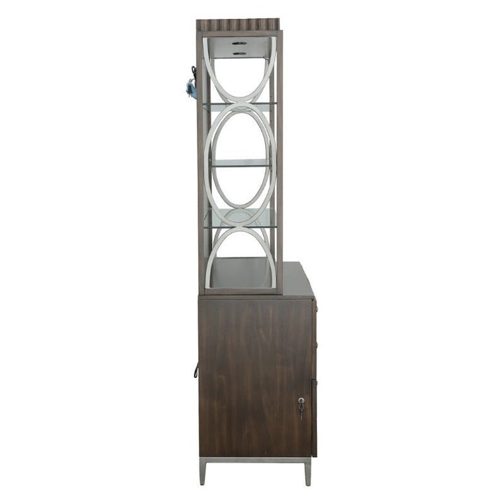 Side view of the West Camden Deck - Fairfield Chair, a tall, wooden cabinet in a sleek Tahitian Pearl finish by Fairfield Chair. The upper section features decorative circular cutouts on metal supports and adjustable glass shelves, while the lower section provides additional storage with a lockable door and drawers.