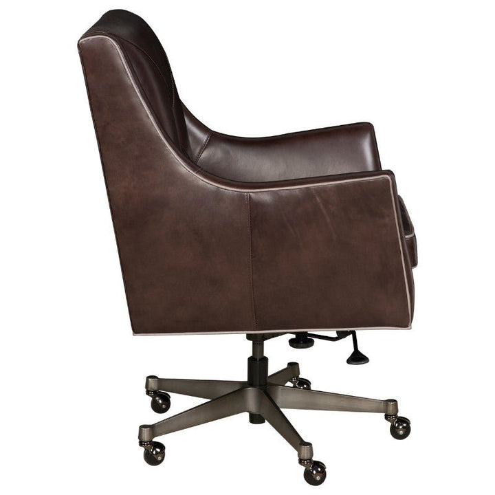 A modern design dark brown Wriggly Office Swivel Chair - Fairfield Chair by Fairfield Chair, viewed from the side, features a high back and no visible armrests. The chair is upholstered in buttery-soft aniline leather and has a metal base with five caster wheels along with an adjustable height lever underneath.